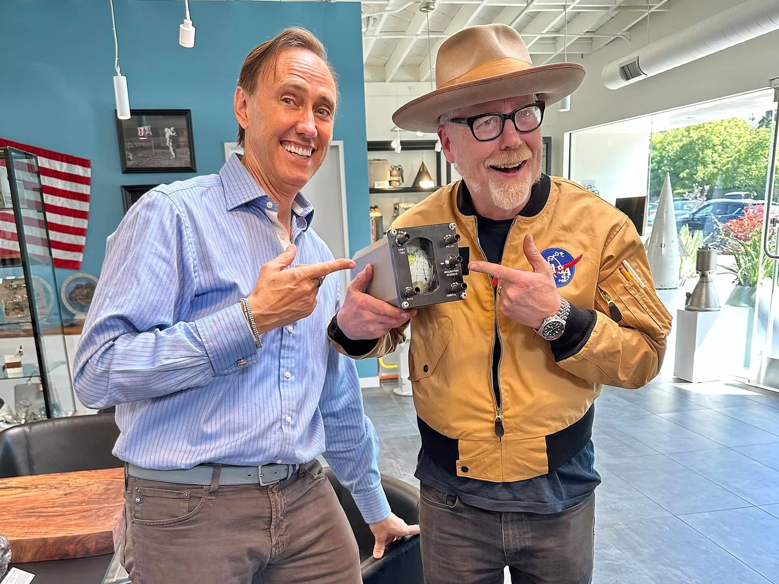 Adam Savage and Steve Jurvetson holding a piece of spaceflight hardware