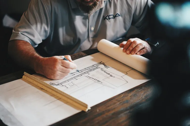 Architect working on a drawing with a pencil and ruler