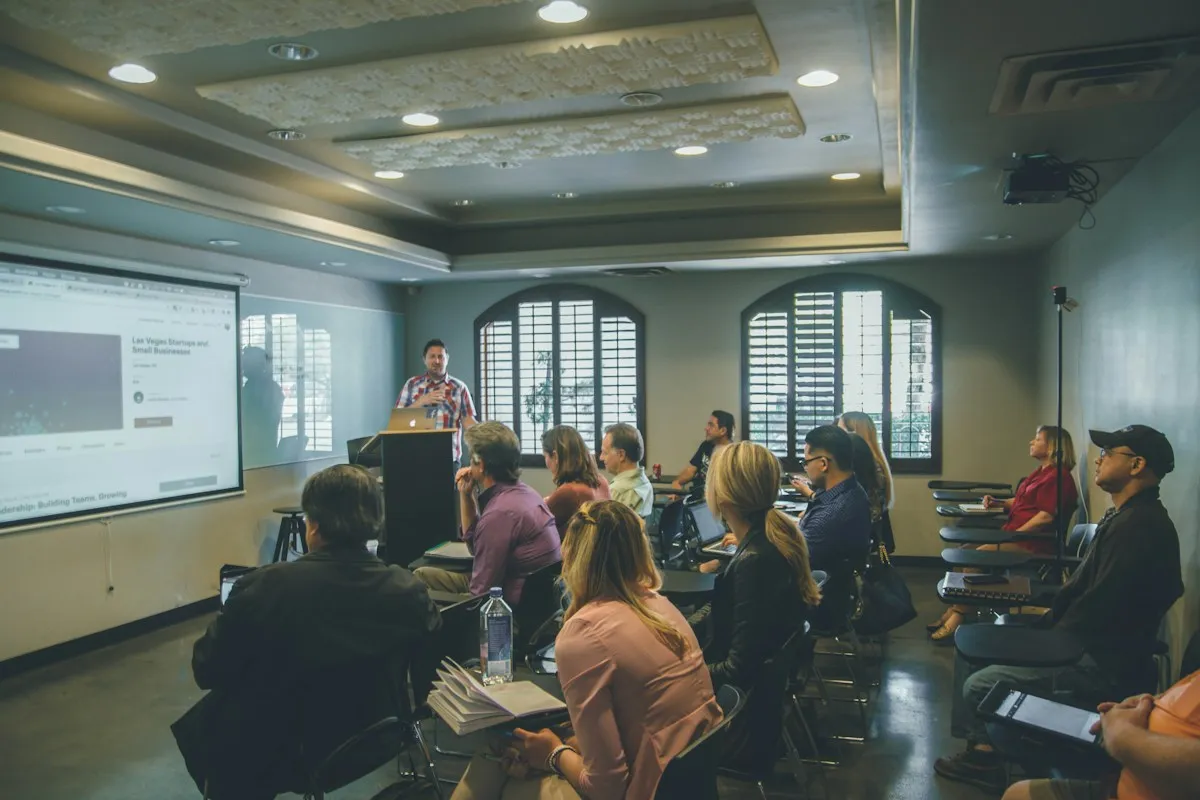 Class in a room with a projector screen