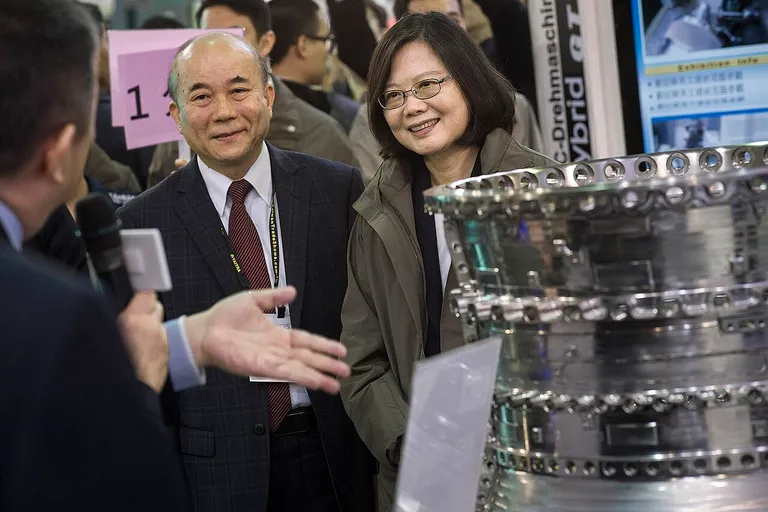 Exhibitor explaining machinery at the Taipei International Machine Tool Show