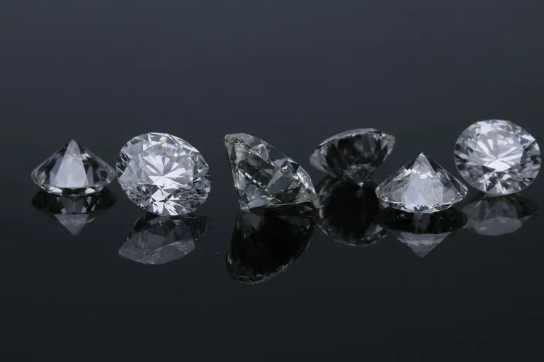 Faceted diamonds on a reflective black surface