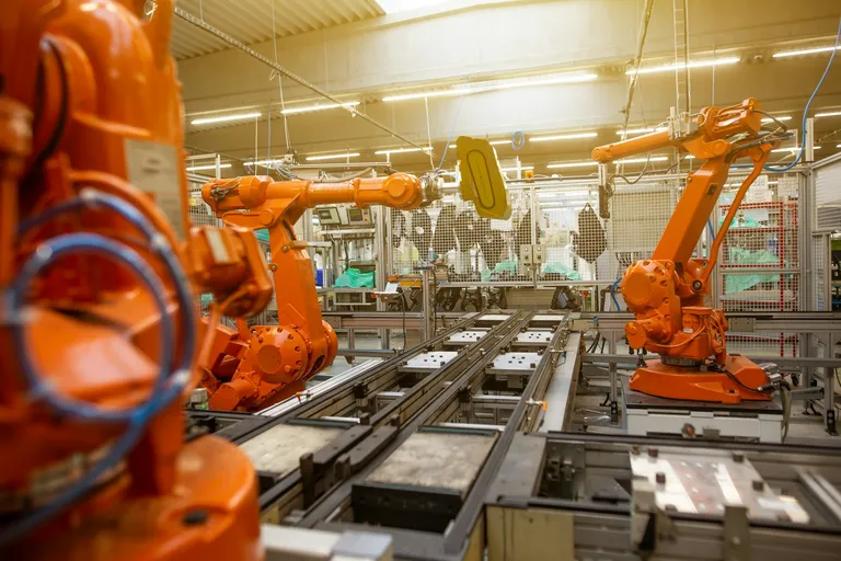 Factory filled with orange industrial robots