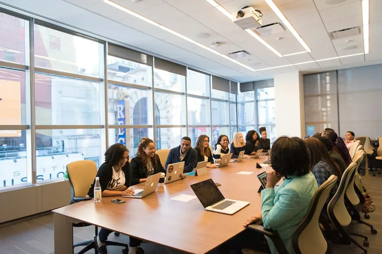 Group working at a table with laptops
