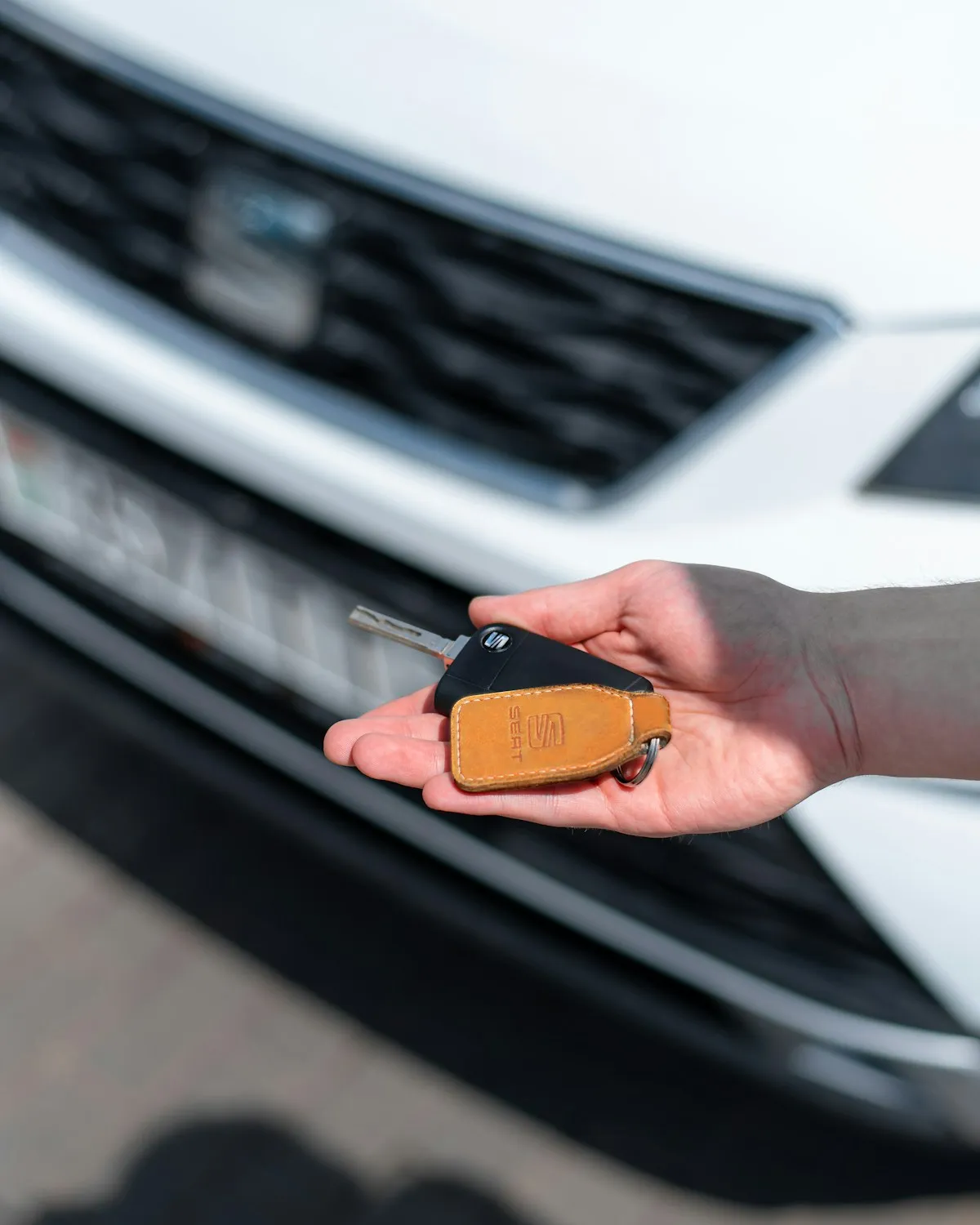 Hand holding a new car key