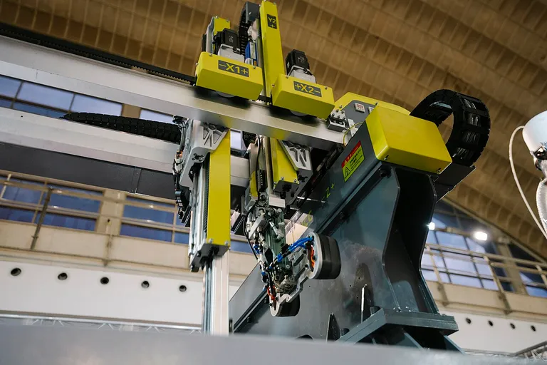 Industrial robot arm working on a production line at a technology exhibition