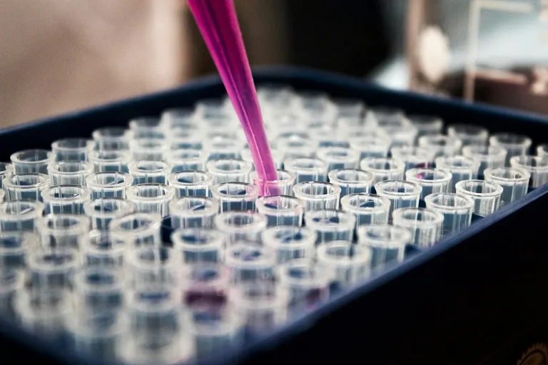 Liquid being added to test tubes in a lab