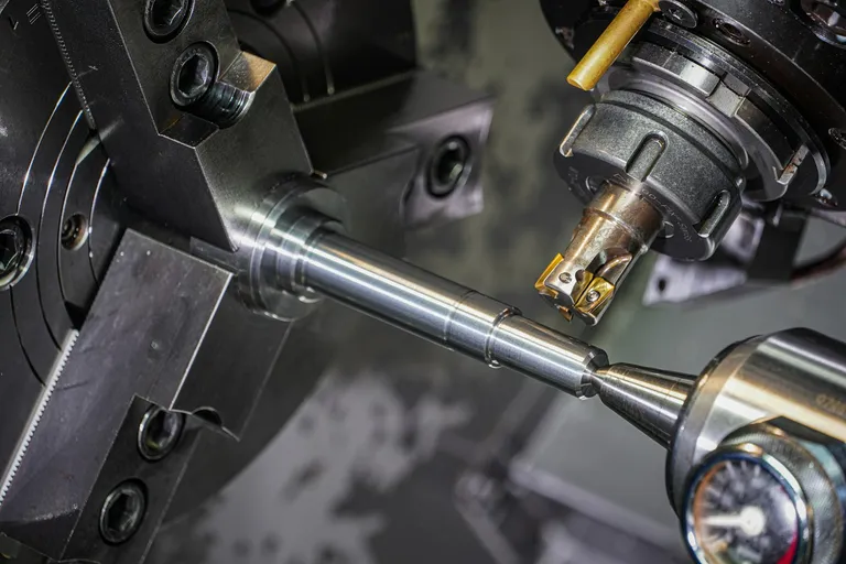 Metal rod being machined on a lathe