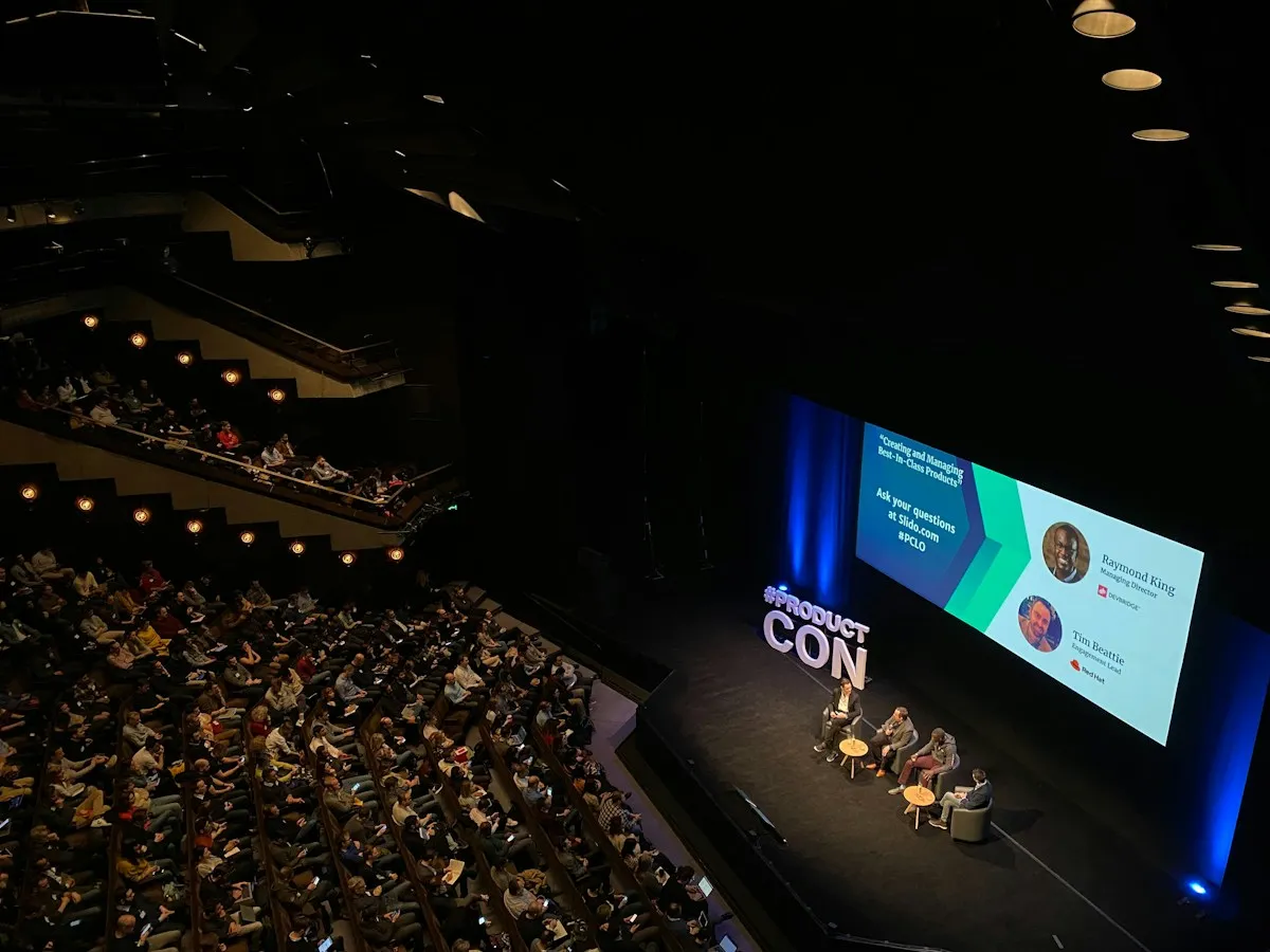Panel discussion on stage in a large auditorium