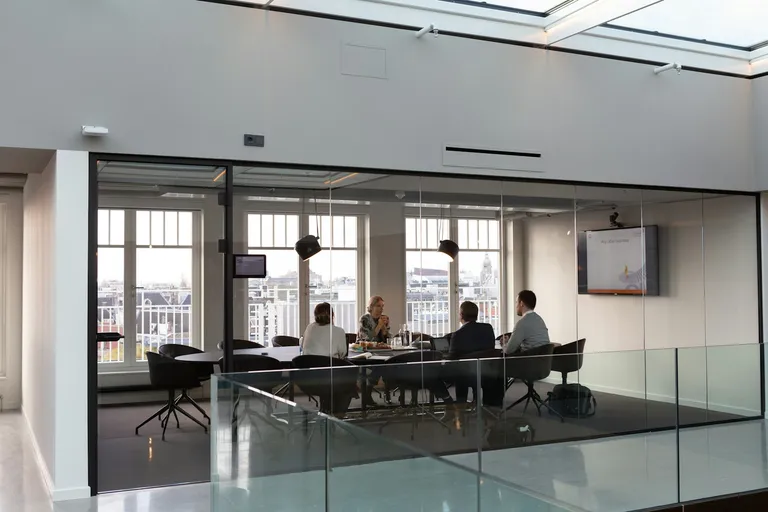 People in a team meeting inside an office