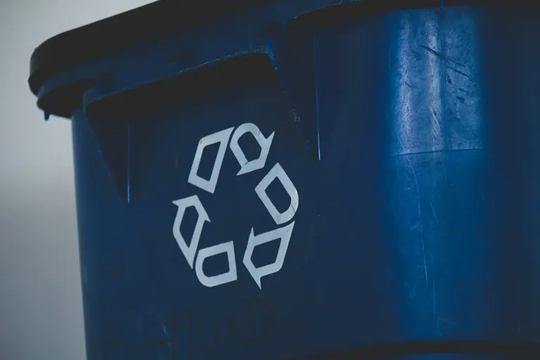 Recycling symbol on a blue bin