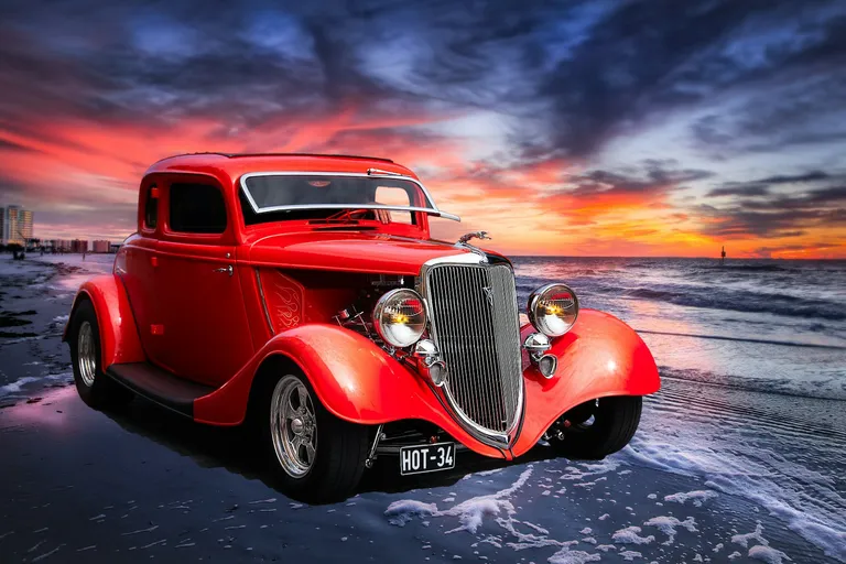 Red classic car on the road