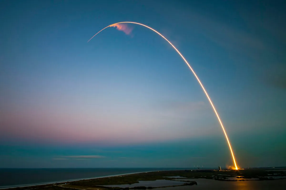 Rocket launch light trail at dusk