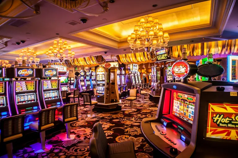 Rows of illuminated slot machines in a casino
