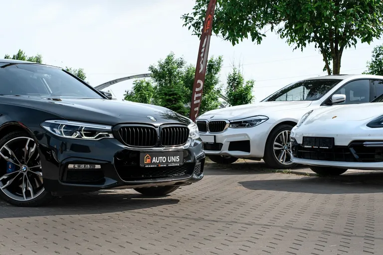 Rows of new cars parked at a dealership