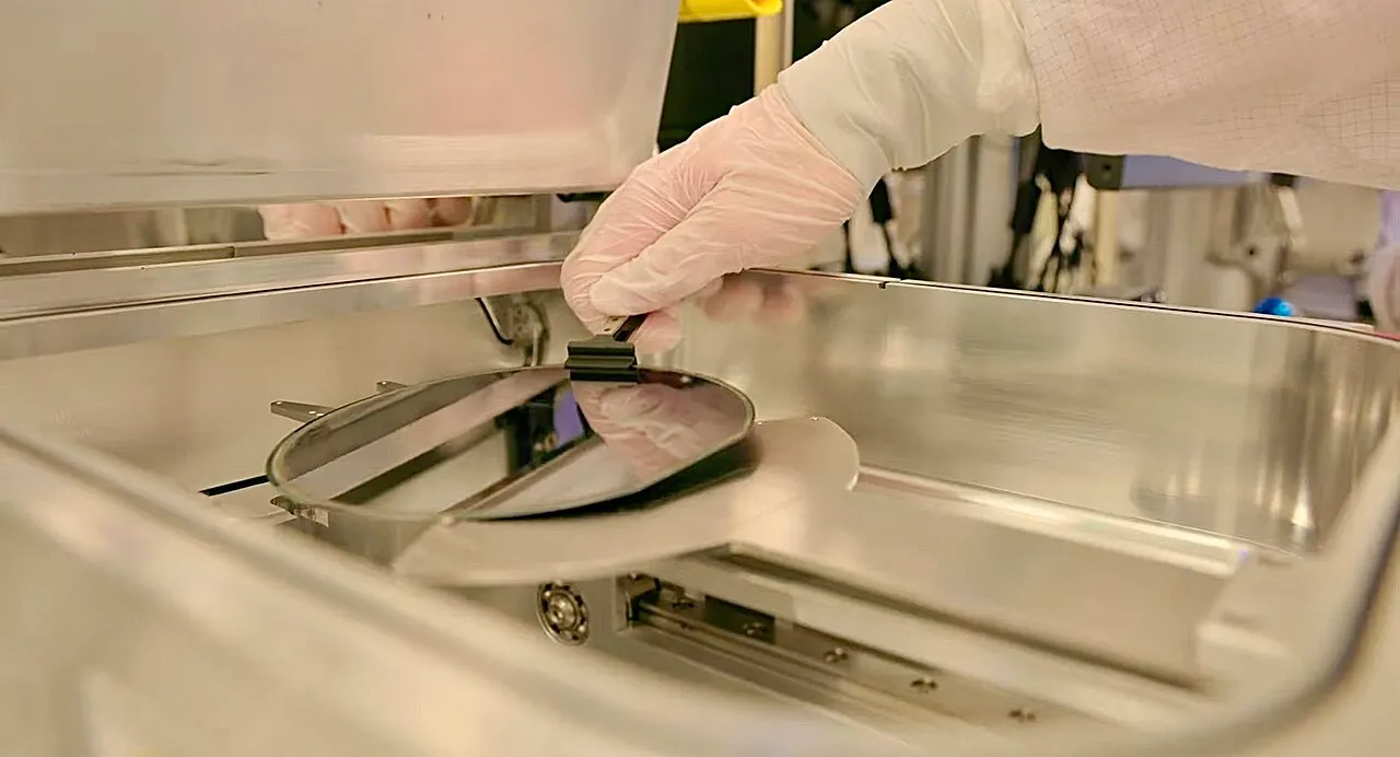 Semiconductor wafer being removed from processing equipment