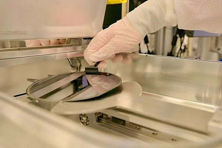 Semiconductor wafer being removed from processing equipment