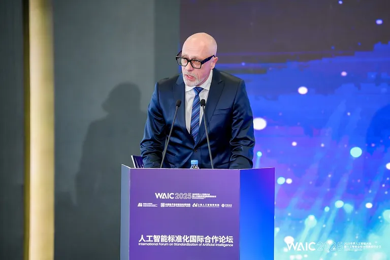 Speaker giving a keynote on stage at the World Artificial Intelligence Conference 2025 in Shanghai