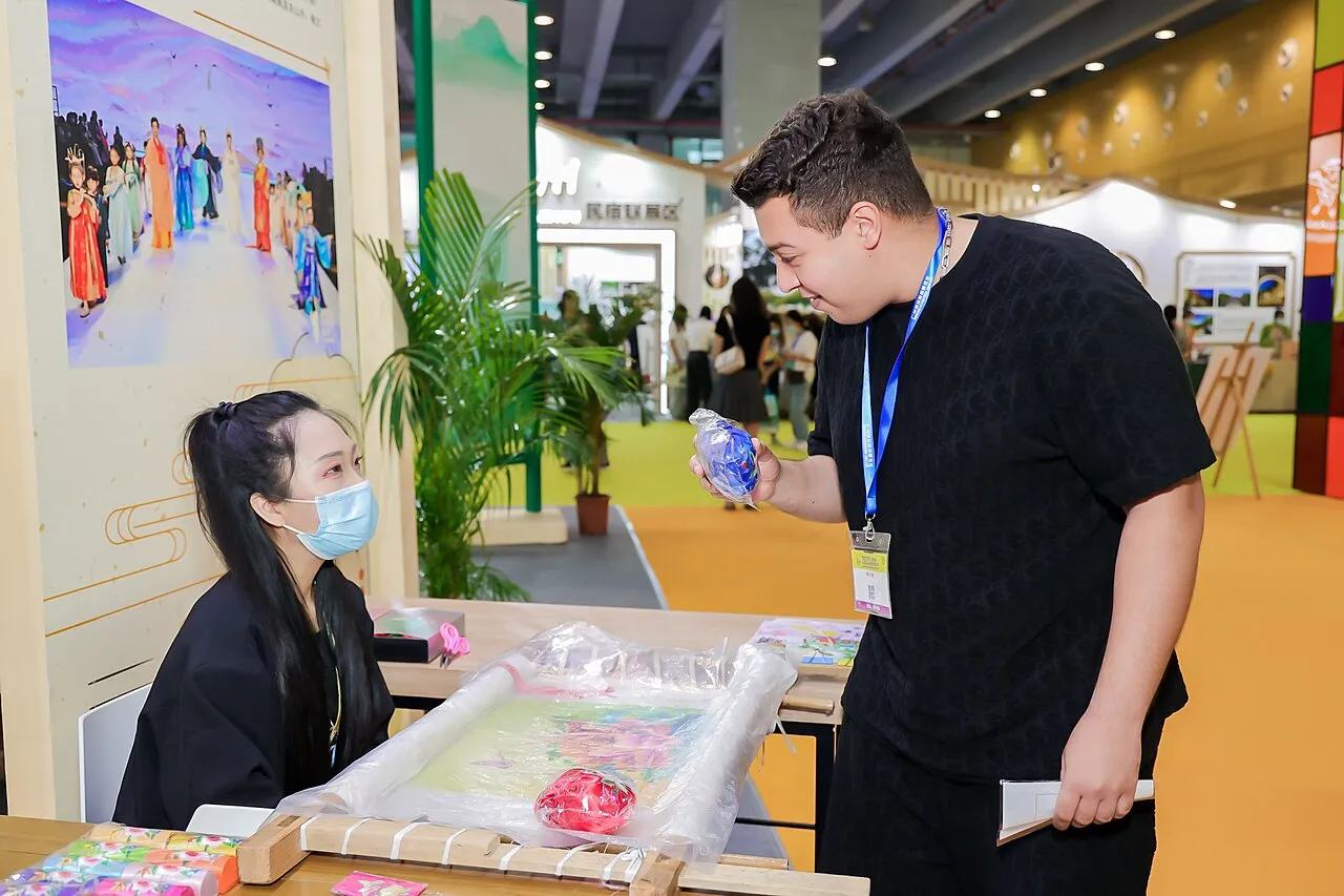 Visitors and exhibitors talking at a booth during the Canton Fair in 2023
