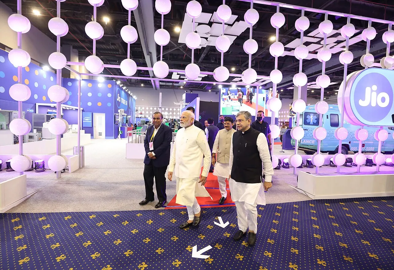 Visitors at an exhibition stand at India Mobile Congress in New Delhi
