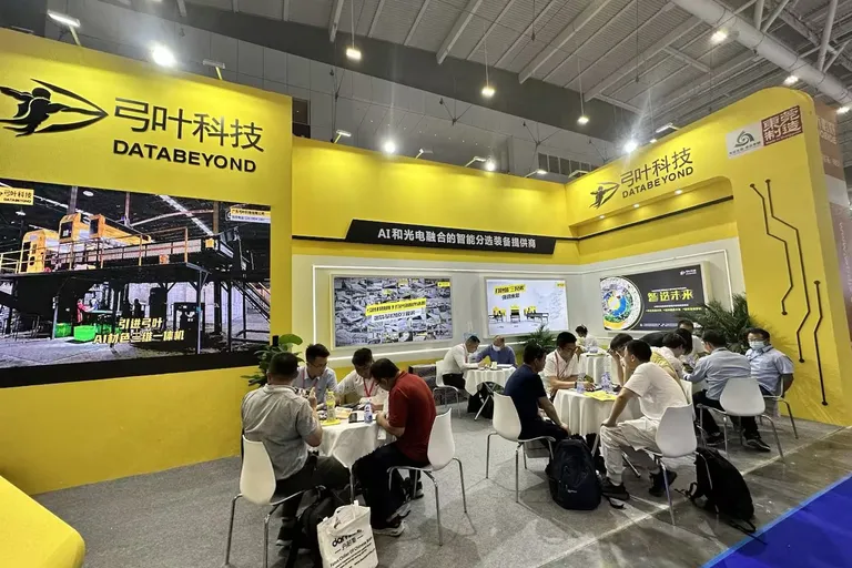 Visitors at an exhibitor stand during the Chinaplas plastics and rubber trade fair