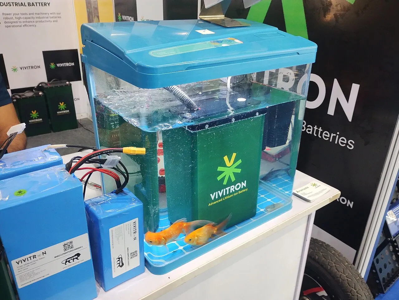 Waterproof lithium-ion battery demonstrated in a fish tank at an EV trade show