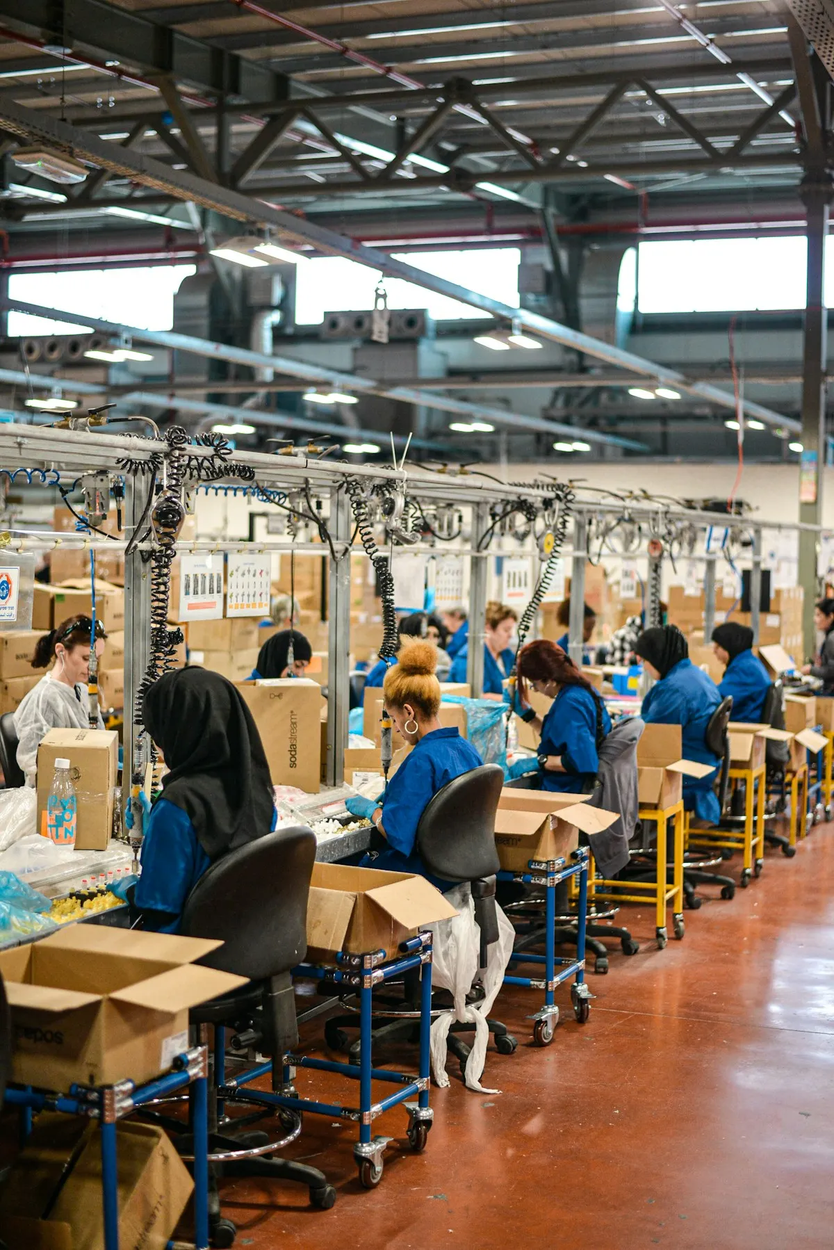 Workers at an assembly line in a large factory