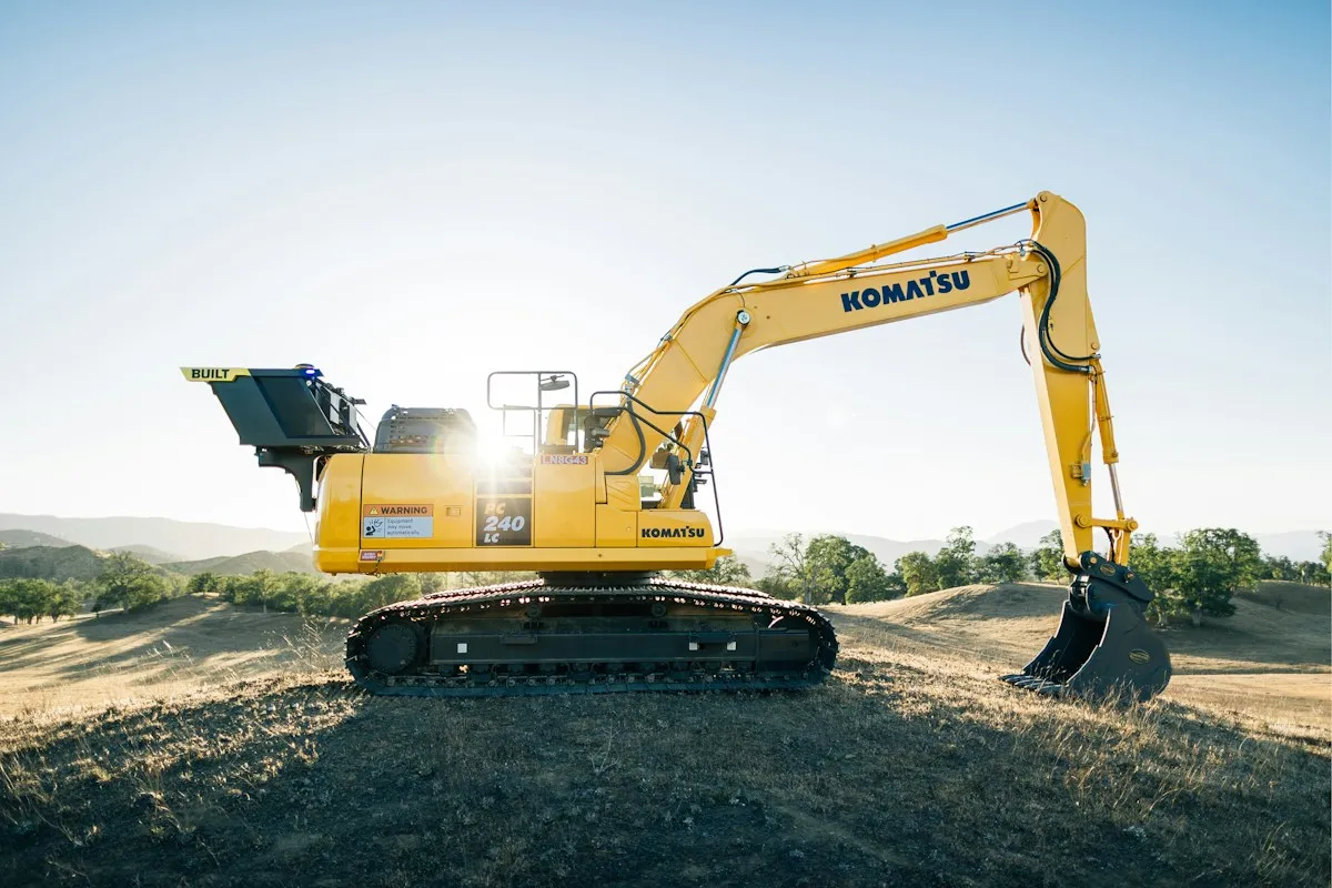 Yellow excavator on a dirt field