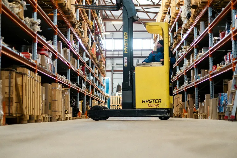 Yellow forklift in a large warehouse